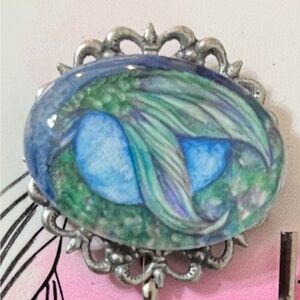 Artistic Silver Brooch with Blue and Green Design